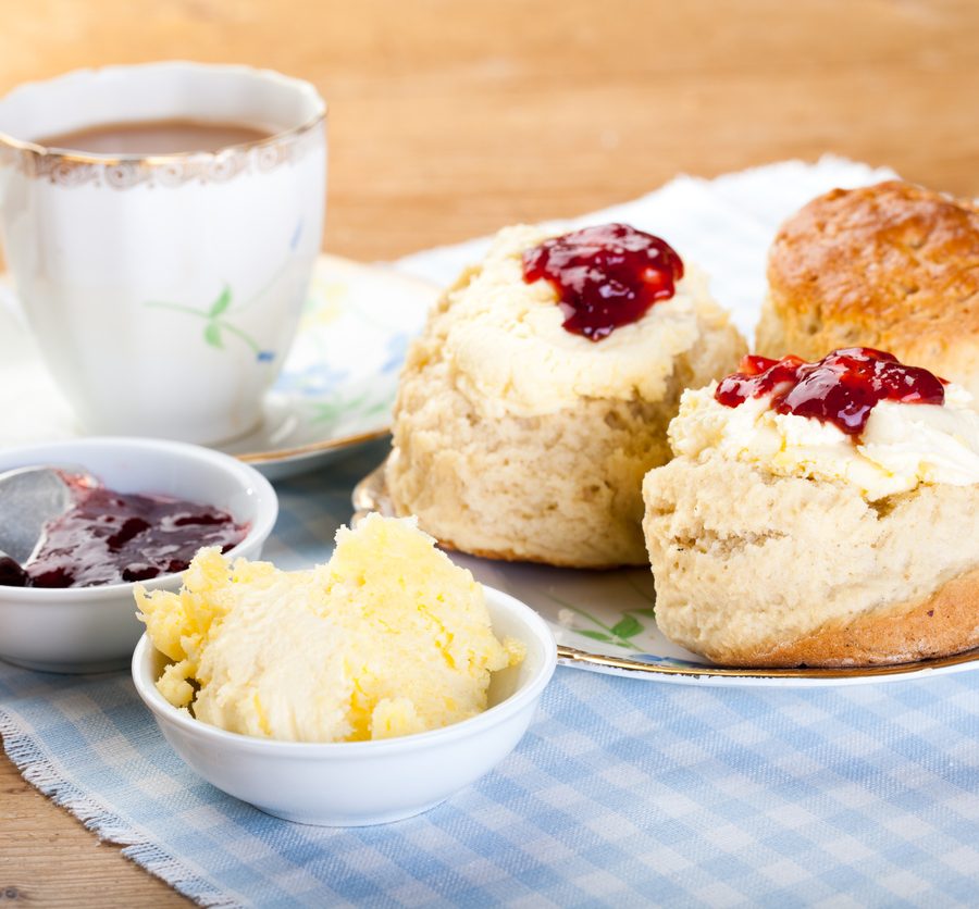 Traditional scones, cream and jam served with a cup of tea